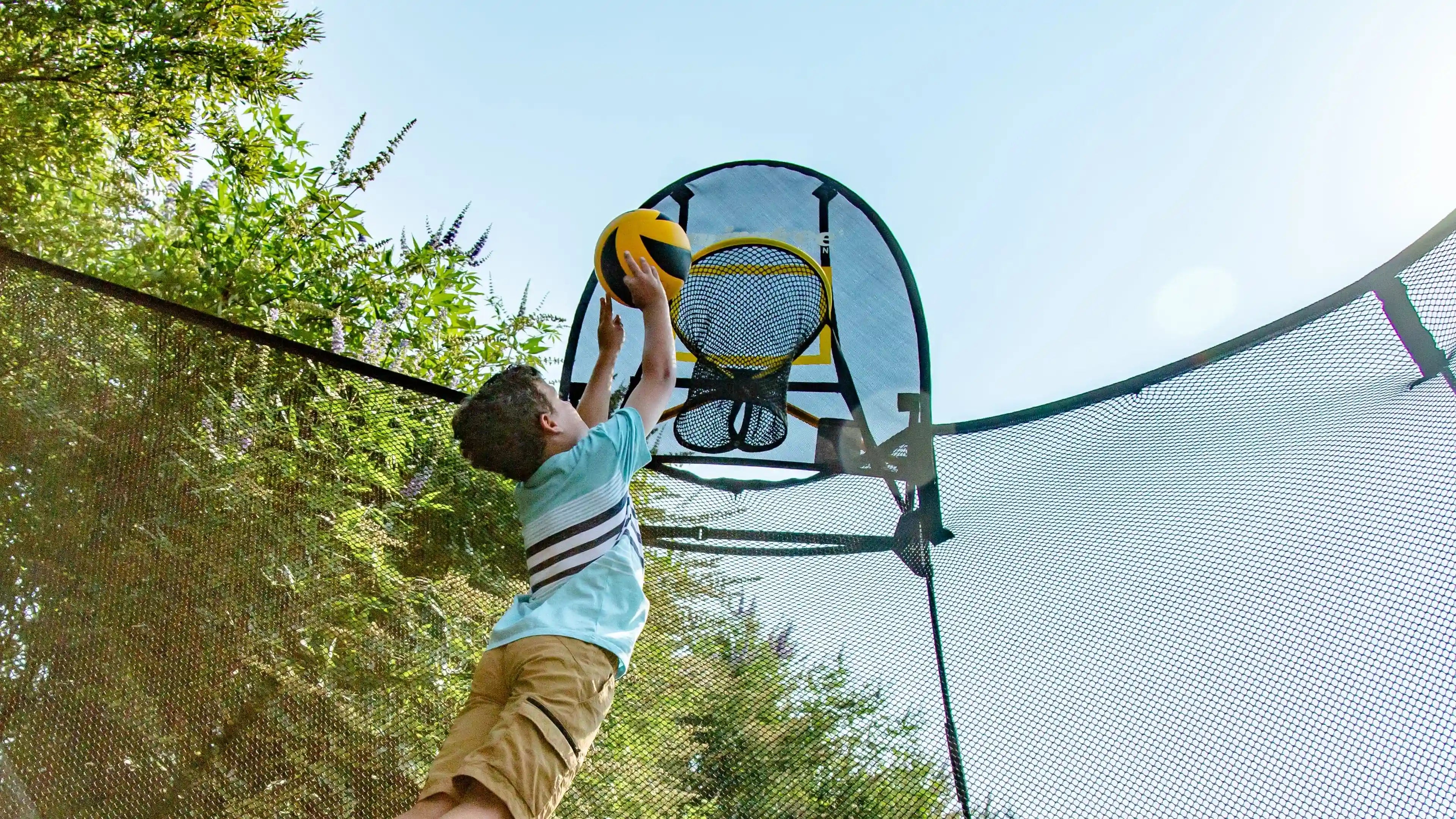 boy playing hoop in a flexrhoop attached to a trampoline