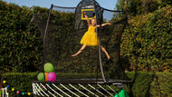 Load image into Gallery viewer, girl jumping happily on a trampoline
