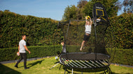 Load image into Gallery viewer, Boy dunking on hoop attached to Trampoline