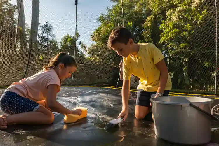 kids cleaning a trampoline