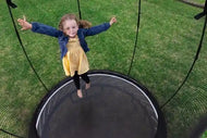 Load image into Gallery viewer, girl jumping on a trampoline