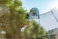 Load image into Gallery viewer, boy playing hoop with a springfree trampoline ball