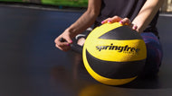 Load image into Gallery viewer, lady pumping the springfree trampoline ball