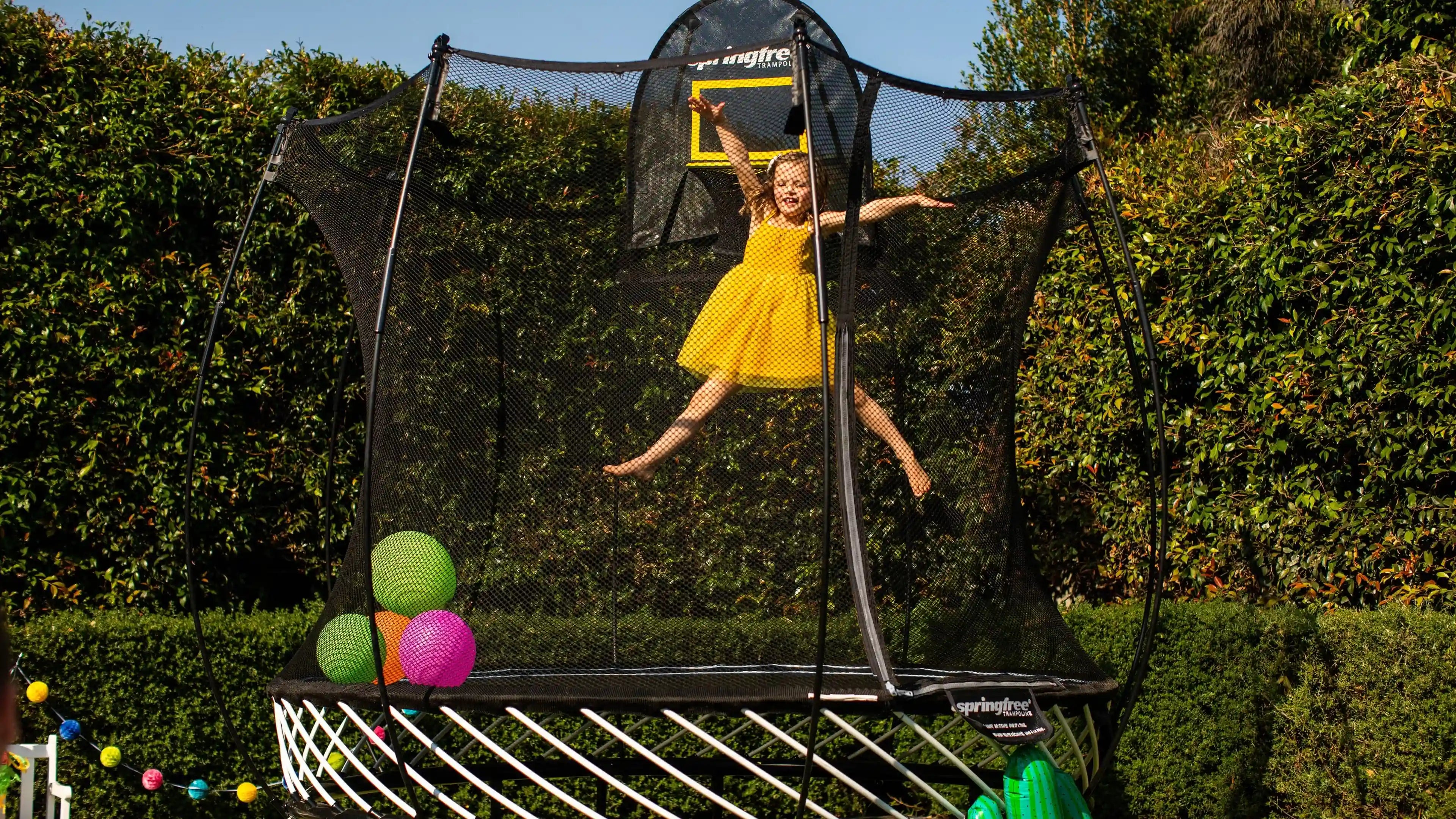 girl jumping happily on a trampoline