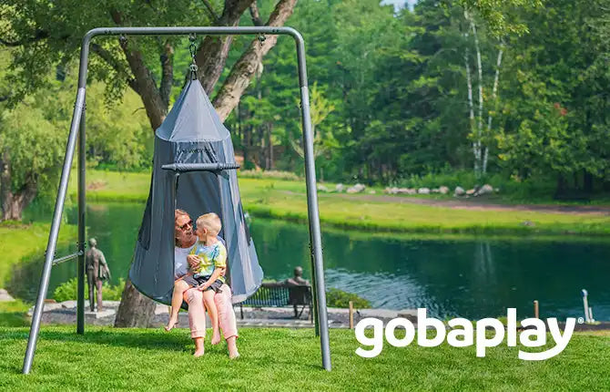 mother and child playing on a swing outdoor