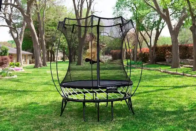 girl jumping on an outdoor trampoline