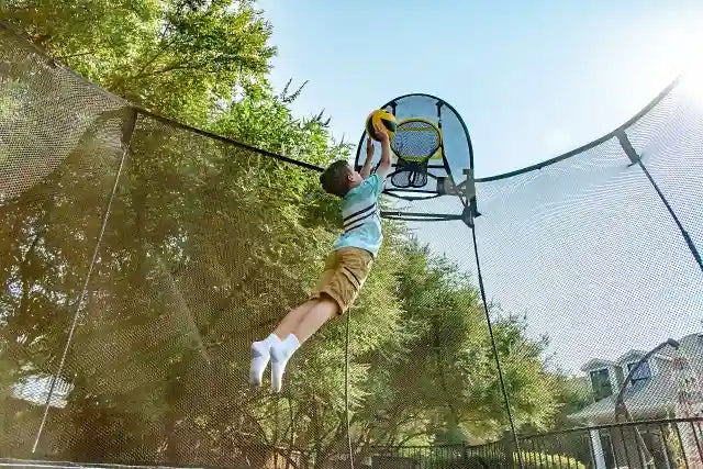 boy playing hoop with a springfree trampoline ball