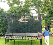 Load image into Gallery viewer, girl jumping very high on an outdoor trampoline

